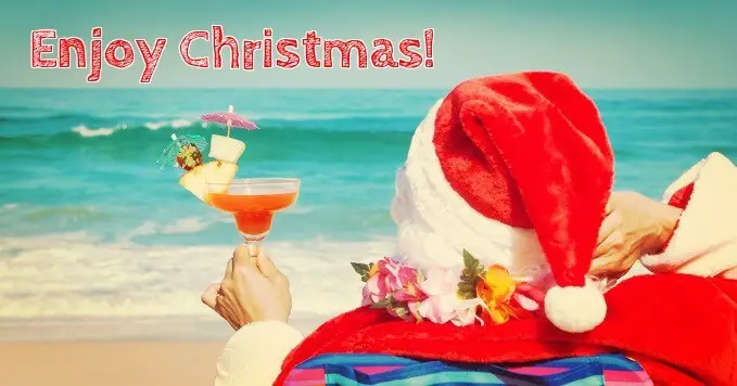 Funny Christmas wishes from Santa in a beach